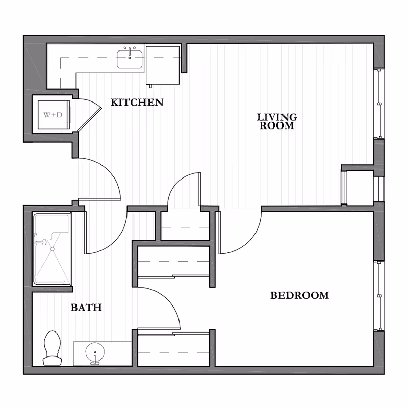 Architectural floor plan of a one-bedroom assisted living unit showing labeled areas including kitchen, living room, bedroom, and bath with fixtures and doors.
