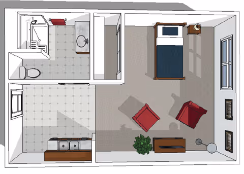 Top-down floor plan of a senior living unit showing a bedroom with a bed, two chairs, a small table, a plant, and a lamp. Adjacent to the bedroom is a bathroom with a shower, toilet, and sink, and a kitchen area with a sink and counter space.