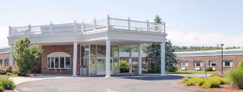 Front entrance of Elaine Center at Hadley with a covered porte-cochère and brick exterior.