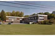 Exterior view of Pontiac Care & Rehabilitation Center with a green lawn and trees.