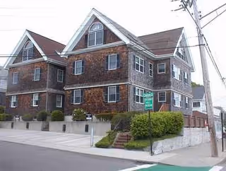 Exterior view of Chilton House Rest Home, a brick building with gabled roofs.