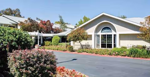 Front exterior view of Holiday Springs of Napa with arched window and landscaped entrance.