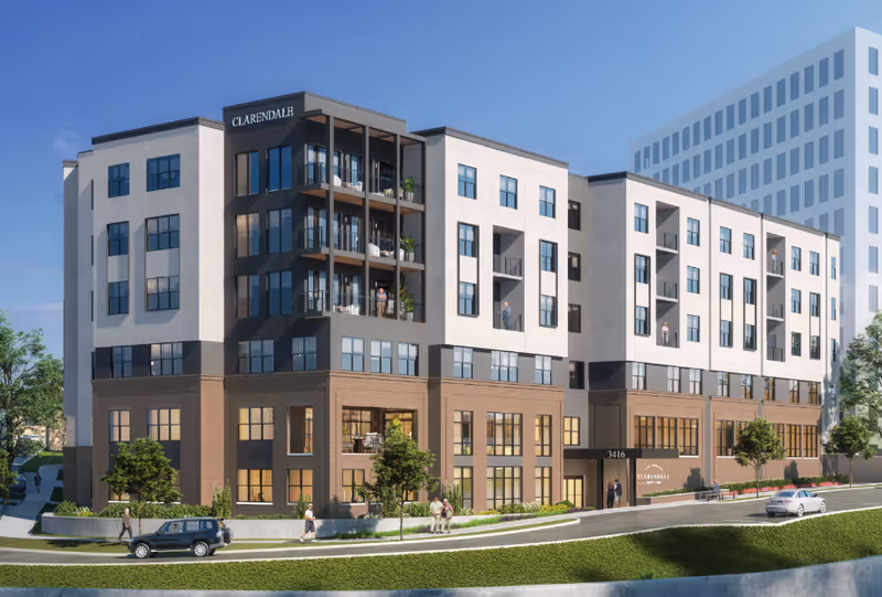 Modern multi-story senior living building with balconies and landscaping along the front.