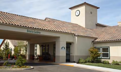 Exterior view of Astoria Senior Living at Tracy entrance with a clock tower.