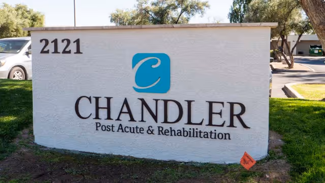 Outdoor white monument sign reading "CHANDLER Post Acute & Rehabilitation" with address number 2121 and a blue logo.