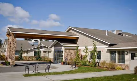 Exterior view of Regency Care Center at Monroe with a covered entrance and landscaped surroundings.