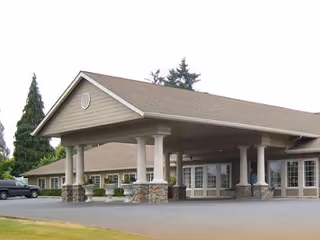 Exterior view of Brookstone Alzheimer's Special Care Center entrance with a covered drop-off area.