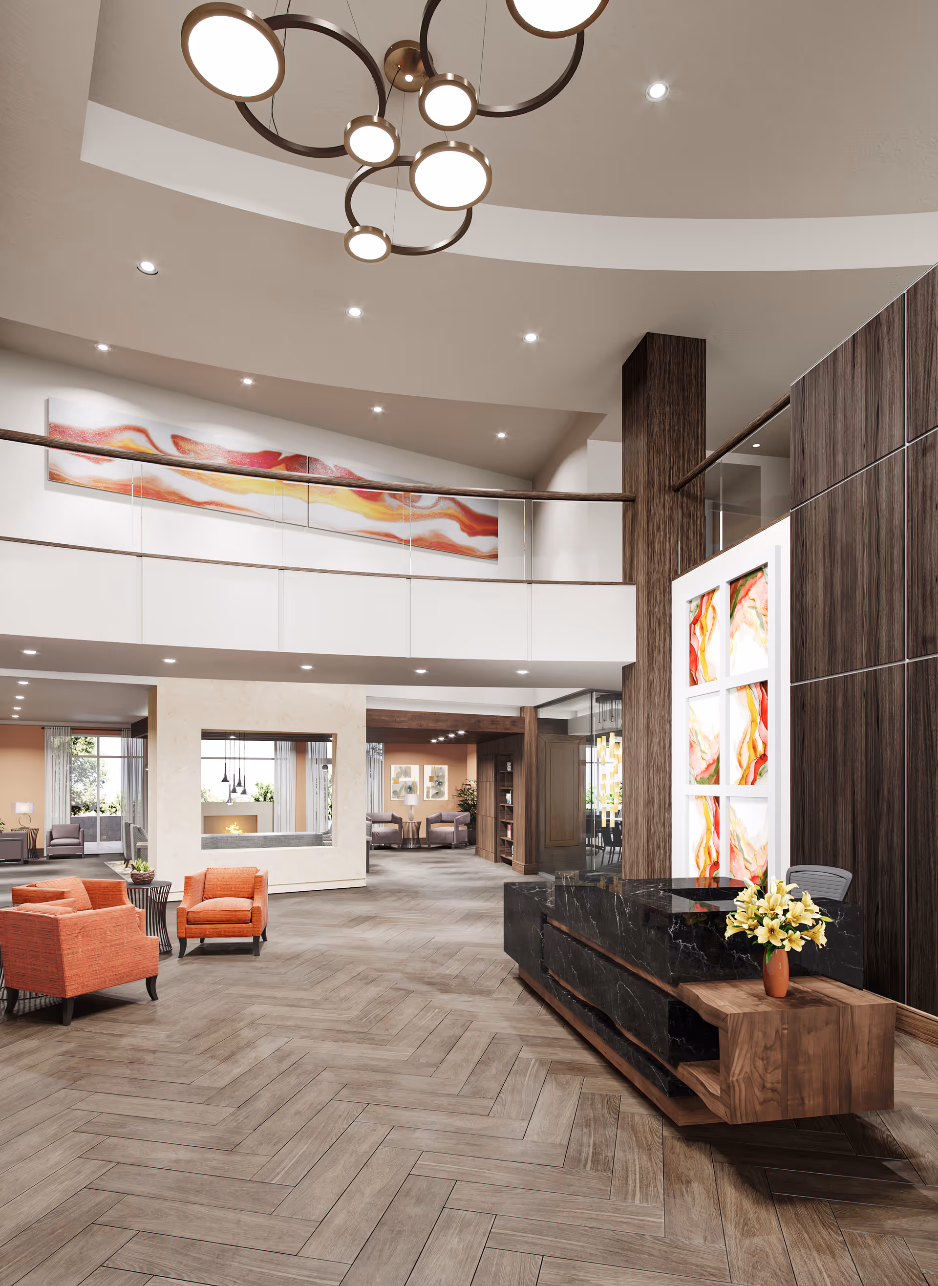 Spacious and modern senior living facility lobby with wood-patterned flooring, a black marble reception desk with a flower vase, orange armchairs, and abstract artwork on the walls. The area features high ceilings with circular light fixtures and a mezzanine level with a railing.