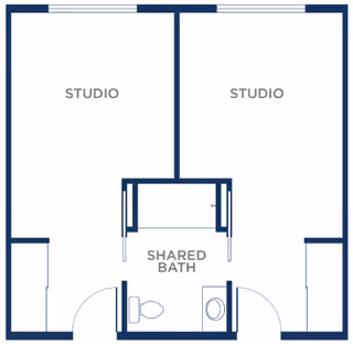Architectural floor plan showing two studio apartments sharing a common bathroom in the center. Each studio has its own entrance and a shared bath area with a toilet and sink.