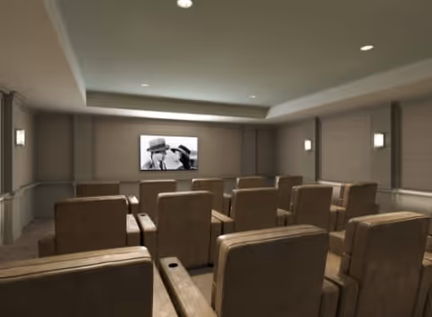 Small private theater room with rows of brown recliner seats facing a wall-mounted screen displaying a black-and-white image.