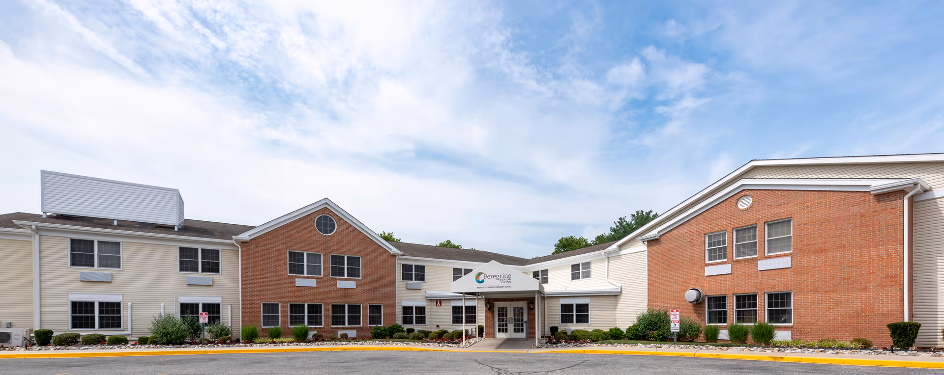 Exterior view of Peregrine Senior Living at Salisbury entrance and parking lot.