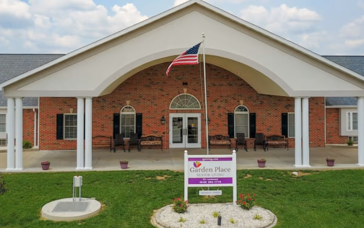 Garden Place Senior Living entrance under a large white portico with an American flag.