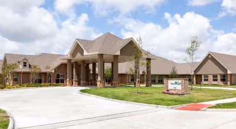 Exterior view of The Rio at Mainland Center with entrance, driveway, and lawn