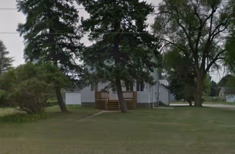 Exterior view of Bentley Manor 2 facility with front porch and trees