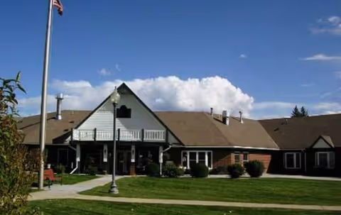Cliffview Assisted Living Center front exterior with flagpole and manicured lawn.