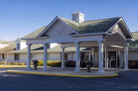 Exterior view of Chandler Creek Post Acute entrance with white columns and a covered portico.