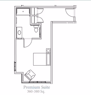 Architectural floor plan of a premium suite at Grand Brook Memory Care of Greenwood, showing a bedroom area with a bed and chair, and an attached bathroom with a shower, toilet, and sink. The suite size is 360-380 square feet.