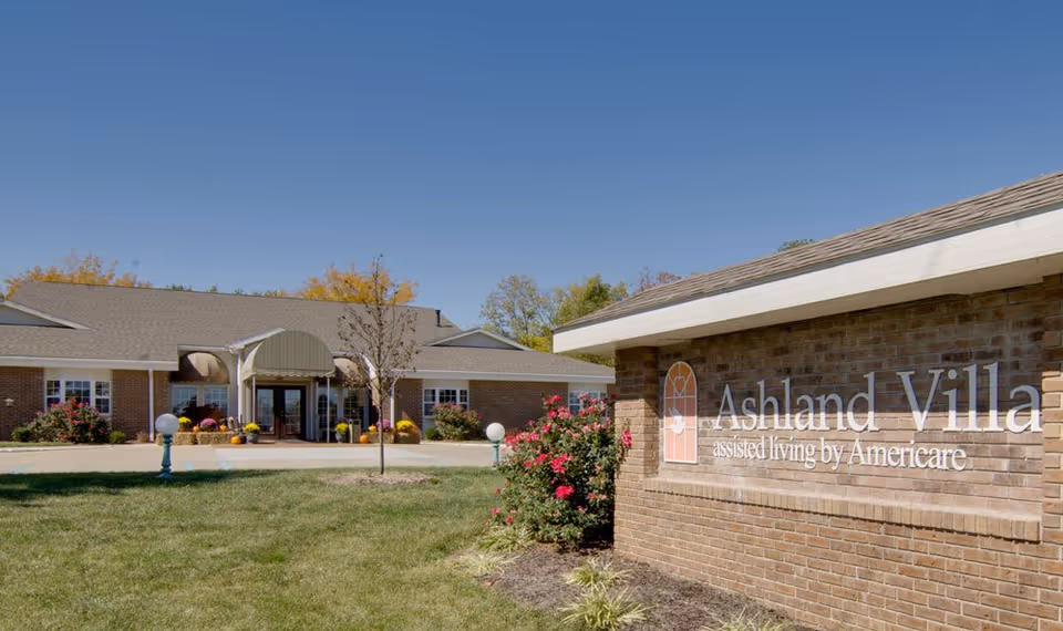 Exterior view of Ashland Villa assisted living facility entrance with sign and landscaping.