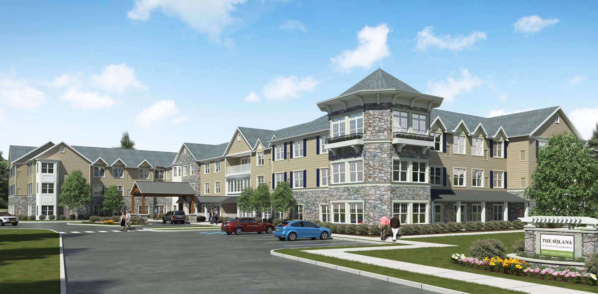 Exterior view of The Solana Doylestown, a multi-story senior living facility with stone and beige siding, multiple windows, a covered entrance, parked cars, and landscaped grounds under a blue sky with some clouds.