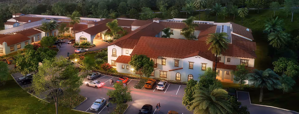 Aerial view of Ridgeview Health Center campus with beige buildings, red-tiled roofs, and parking.