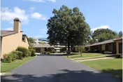Wide driveway leads to Lutheran Village with low-rise buildings and trees.