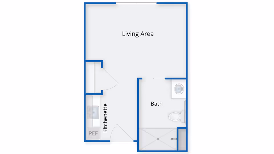 Floor plan of a small living space showing a living area, kitchenette, and a bathroom with a shower, toilet, and sink.