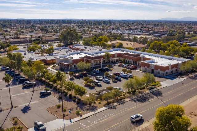 Aerial view of the Mission Palms Post Acute building, surrounding parking lot, and nearby suburban neighborhood.