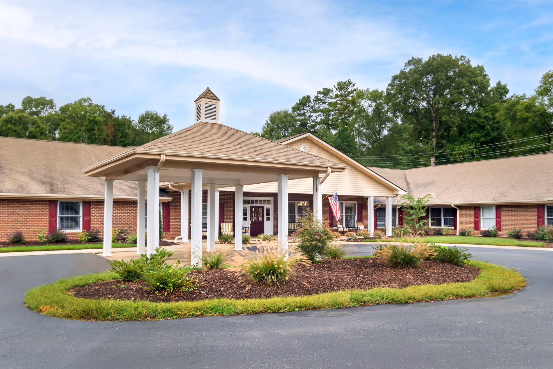 Exterior view of Brookdale Union with circular driveway, covered entrance, and brick building.