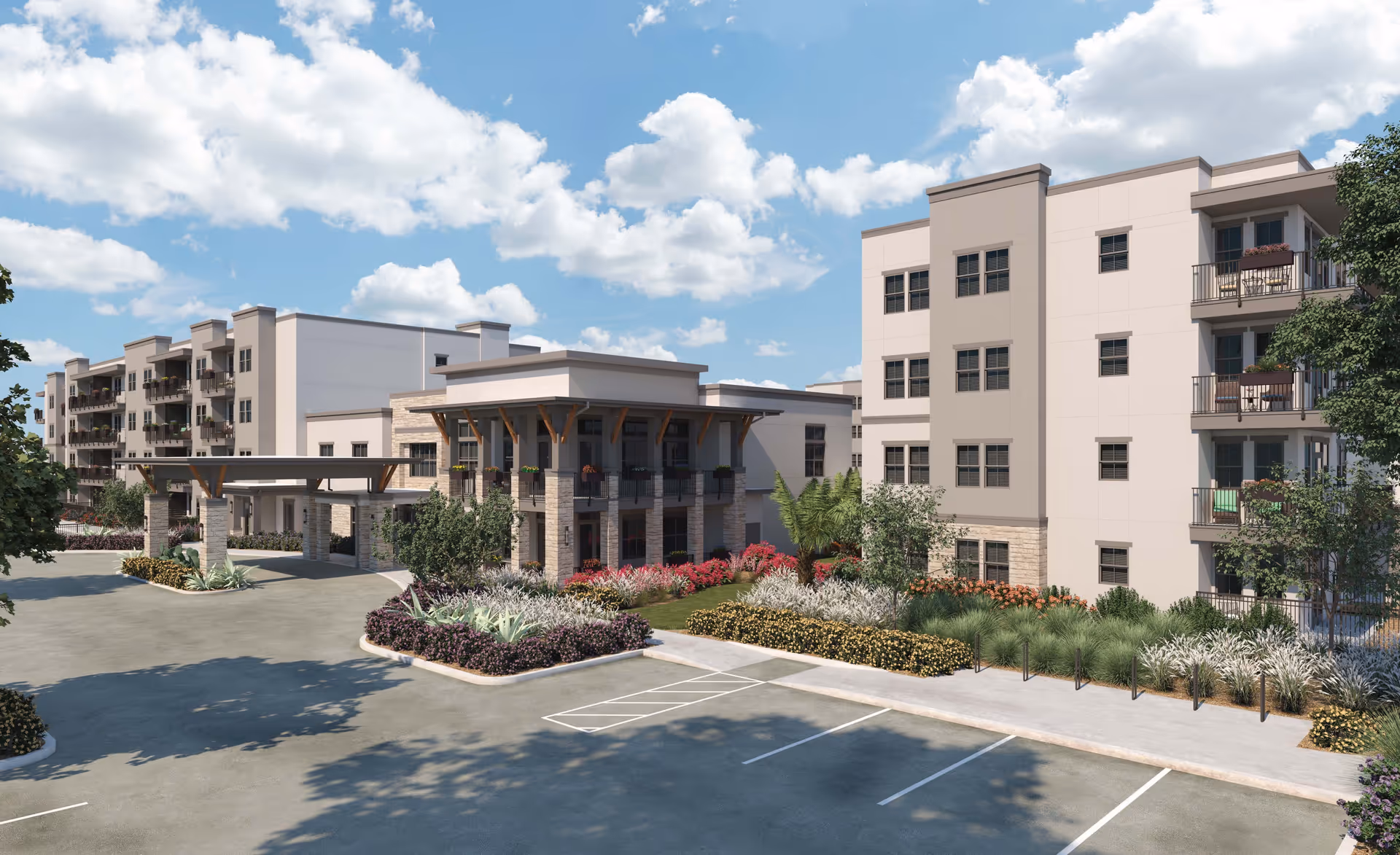 Exterior view of a modern multi-story senior living facility named Mera Goodyear, featuring beige and light gray walls, balconies with railings, a covered entrance supported by stone pillars, landscaped gardens with various shrubs and flowers, and a parking area in the foreground under a partly cloudy blue sky.