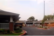 Exterior view of Lakeside Post Acute with brick buildings and a curved driveway.