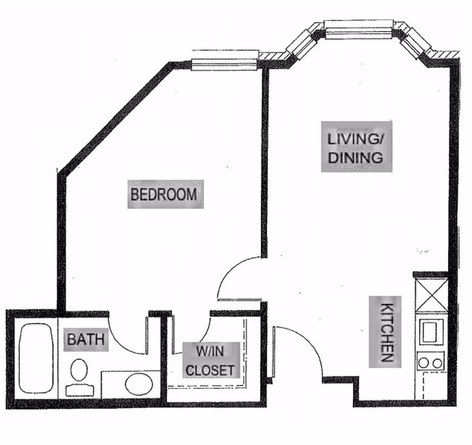 Floor plan of a one-bedroom apartment showing a bedroom, bathroom, walk-in closet, kitchen, and combined living/dining area.
