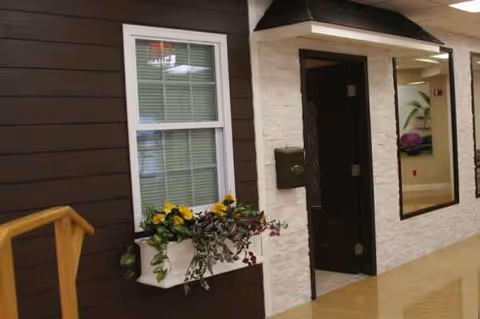 Exterior view of Medford Multicare Center entrance with window, planter, and walkway.