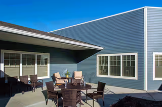 Marquis Mill Park exterior with a covered patio and brown outdoor seating.