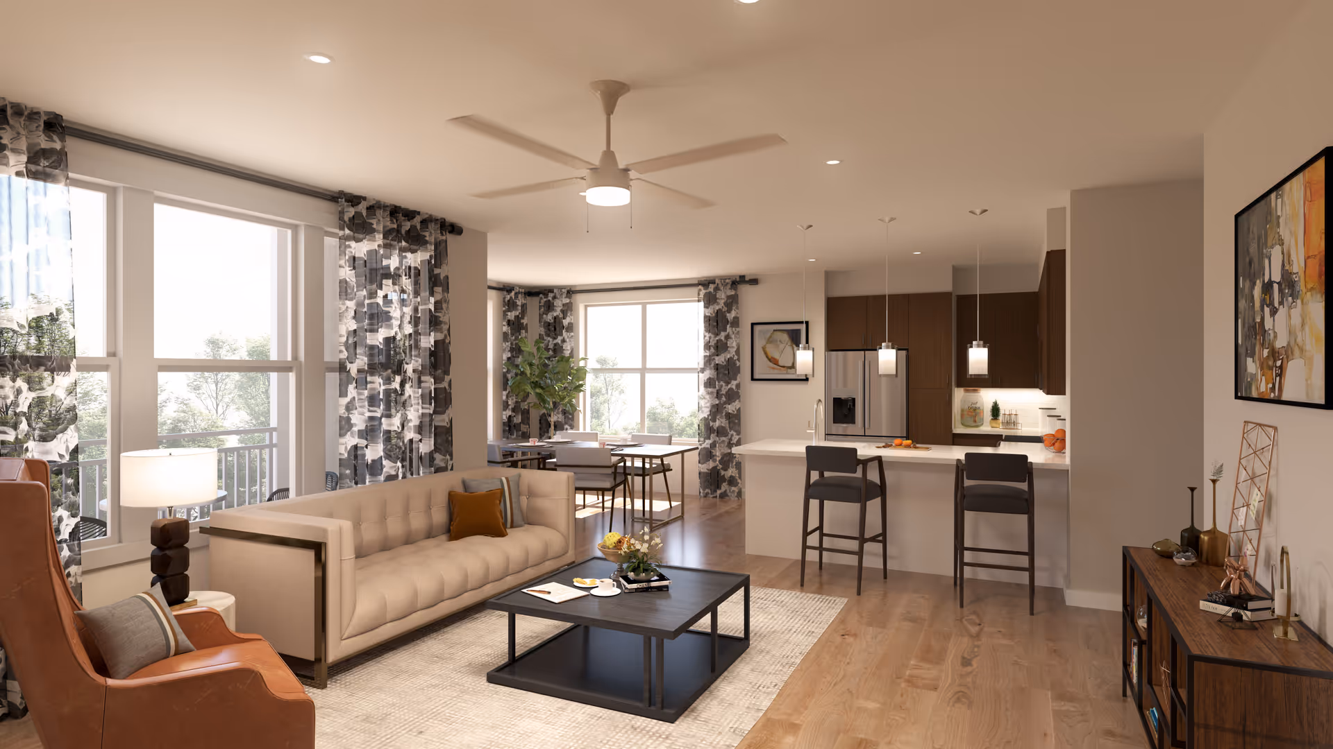 A modern open-concept living area with a beige tufted sofa, a brown leather armchair, a black coffee table with a book and a cup, and a dining table with chairs near large windows with patterned curtains. The kitchen area features a white island with two bar stools, pendant lights, and wooden cabinets with a stainless steel refrigerator.