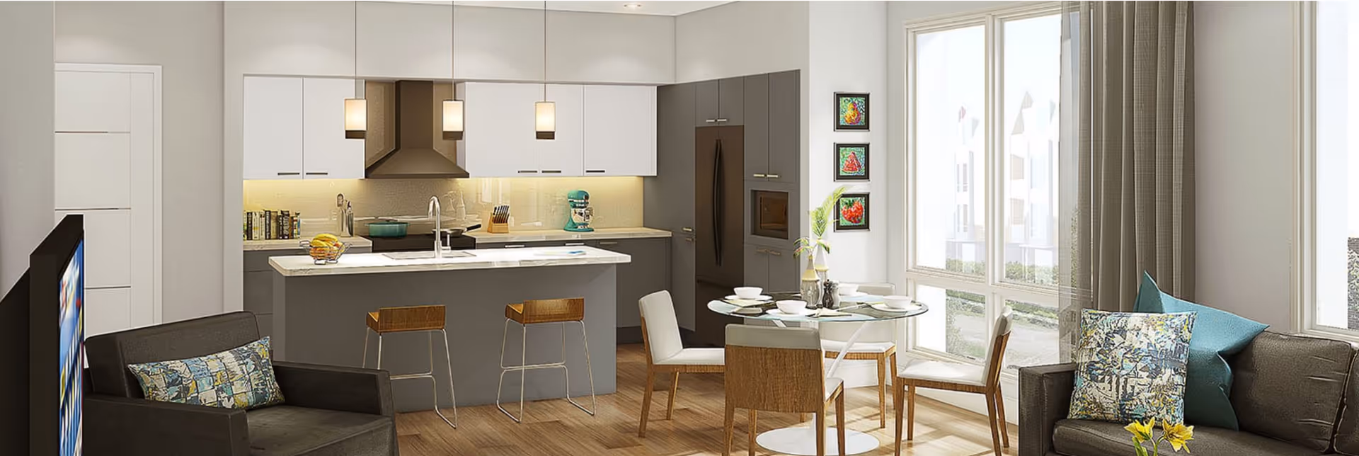 A modern open-concept living space featuring a kitchen with white and gray cabinetry, a kitchen island with two bar stools, a round dining table with four chairs, and a living area with two armchairs and a sofa. The room is well-lit with large windows and decorated with colorful artwork and cushions.