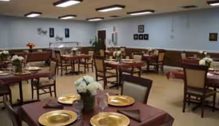 Empty dining room in a senior facility with arranged tables.