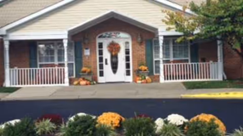 Arden Courts Kensington front entrance with wreath, pumpkins, and flower landscaping.