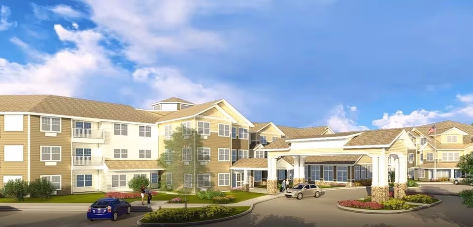 Exterior view of a multi-wing senior living facility with entrance canopy and landscaped roundabout.