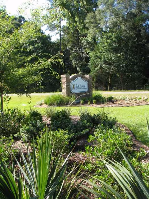 Oak Haven Community Care Center sign surrounded by landscaped lawn and trees.