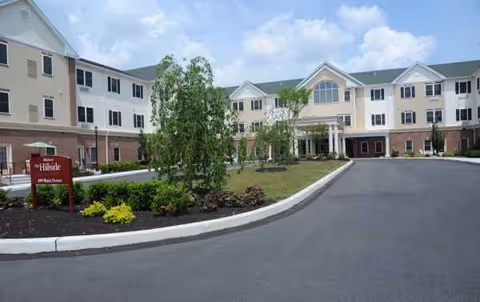 Exterior view of Arbour Square of Harleysville with a circular driveway and landscaped entrance.