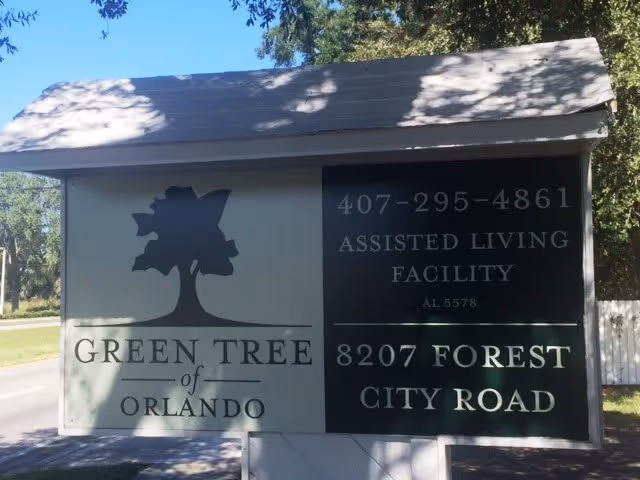 Outdoor sign reading "GREEN TREE of ORLANDO" with contact info and address for an assisted living facility.