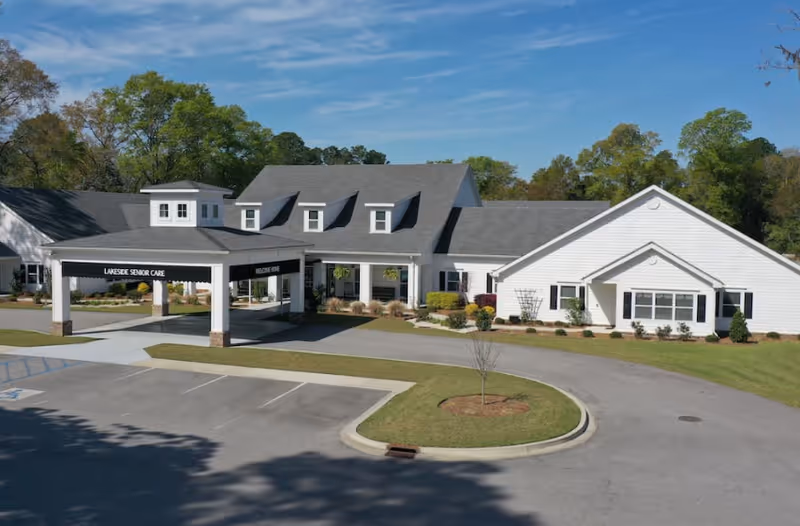 Exterior view of Lakeside Senior Living facility with entrance canopy and parking lot.