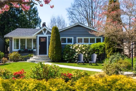 Front view of Hillside Homes exterior with lawn and two chairs on the grass.