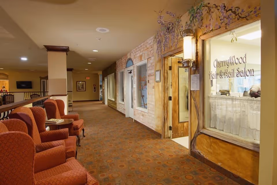 Carpeted interior hallway with upholstered seating and the entrance to CherryWood Hair & Nail Salon.