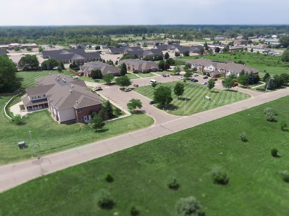Aerial view of the Landings of Genesee Valley campus with multiple residential buildings, parking lots, and landscaped lawns.