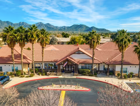 Front view of The Auberge at Scottsdale exterior with red-tiled roof and palm trees.