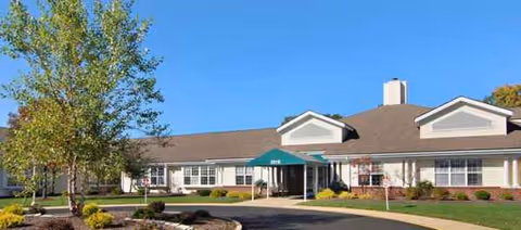 Exterior view of Ontario Estates Senior Living, a single-story building with green awning entrance and landscaping.