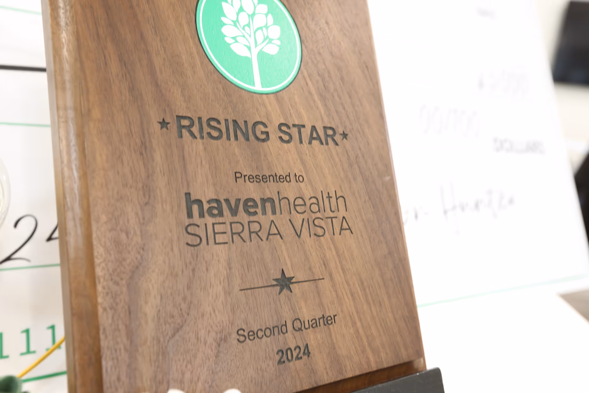 Close-up of a wooden "Rising Star" award plaque presented to Haven Health Sierra Vista for Second Quarter 2024.