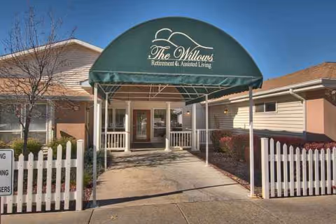 Front entrance of The Willows Retirement & Assisted Living under a green canopy.
