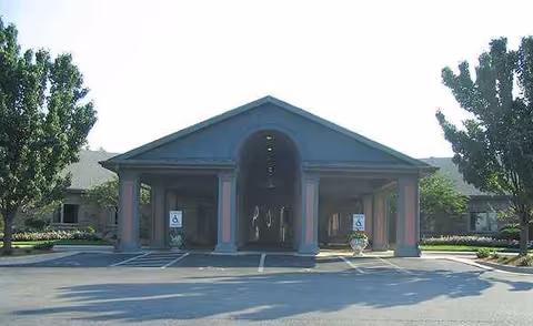 Front exterior of Manor at Elfindale featuring a covered entrance and handicap parking.